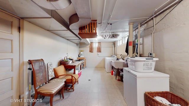 interior space featuring laundry area, washer and clothes dryer, and light floors