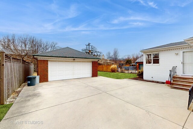 detached garage featuring fence