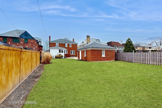 view of yard with a fenced backyard and an outdoor structure