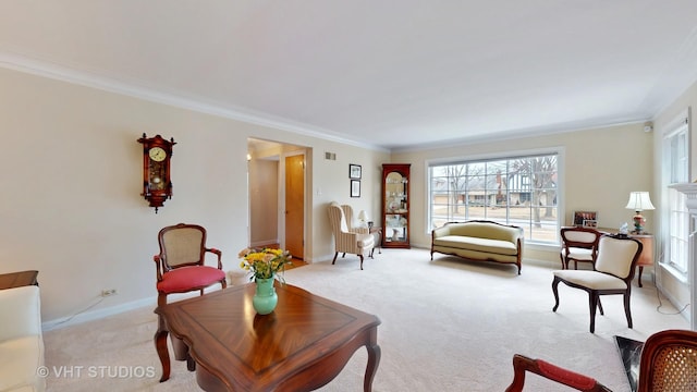 living area featuring light carpet, crown molding, and baseboards