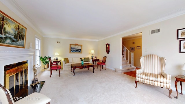 carpeted living room featuring stairway, visible vents, crown molding, and a glass covered fireplace