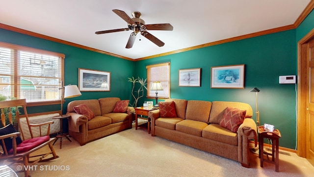 carpeted living area featuring a ceiling fan and crown molding