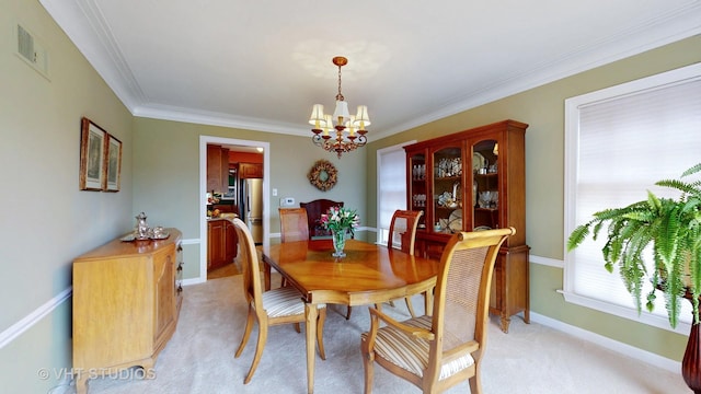 dining area with a chandelier, light carpet, visible vents, baseboards, and crown molding