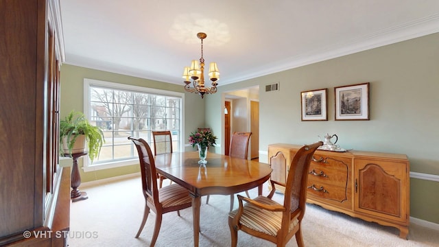 dining area featuring a notable chandelier, crown molding, visible vents, and light colored carpet