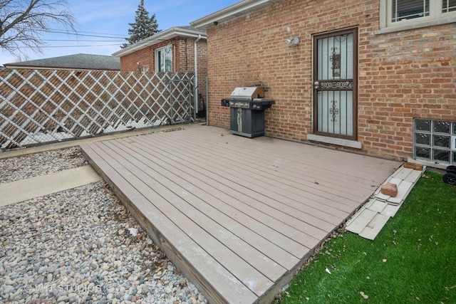 deck featuring area for grilling and fence