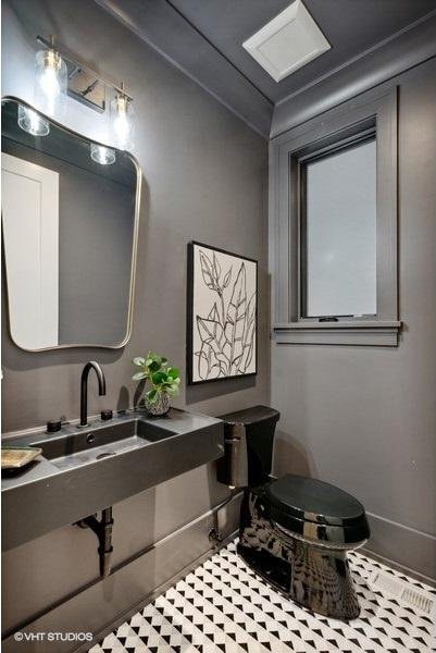 bathroom with a sink and baseboards