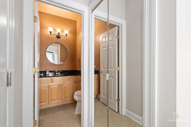 bathroom featuring toilet, vanity, and tile patterned floors