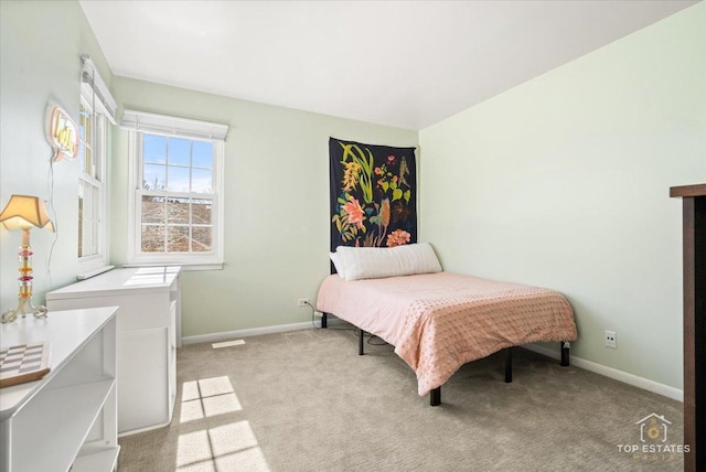 bedroom with light carpet and baseboards