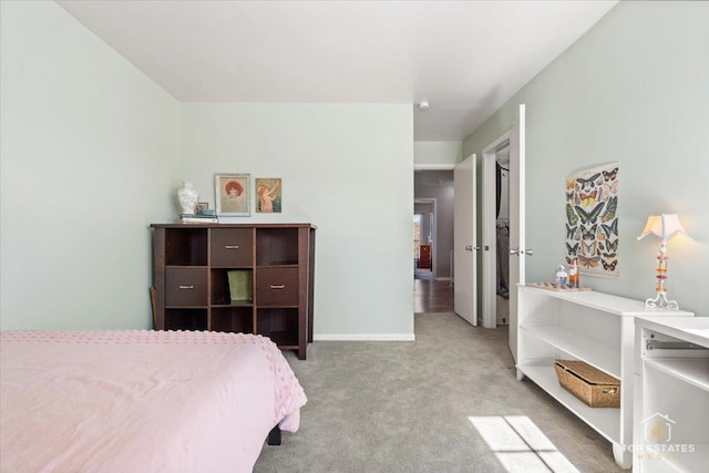 carpeted bedroom featuring baseboards