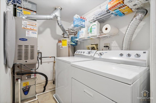 washroom with laundry area, water heater, and independent washer and dryer