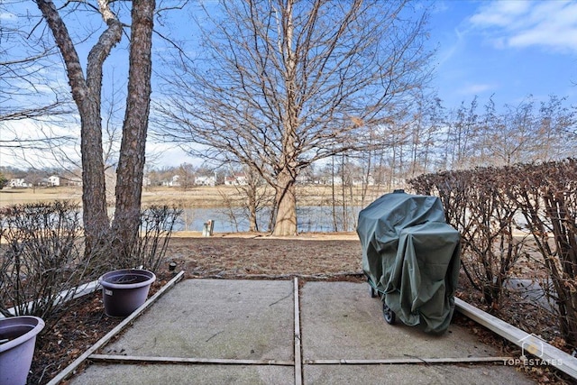 view of yard with a water view and a patio area