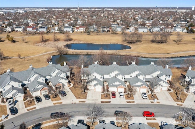 drone / aerial view featuring a residential view and a water view