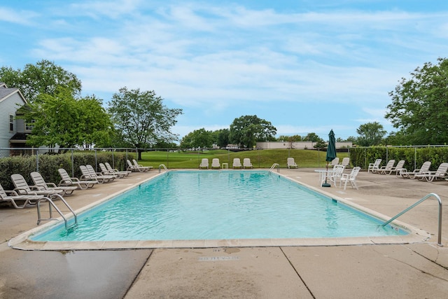 pool with a yard, a patio area, and fence