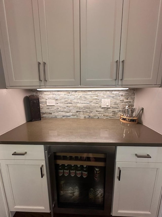 bar with a dry bar, beverage cooler, and tasteful backsplash