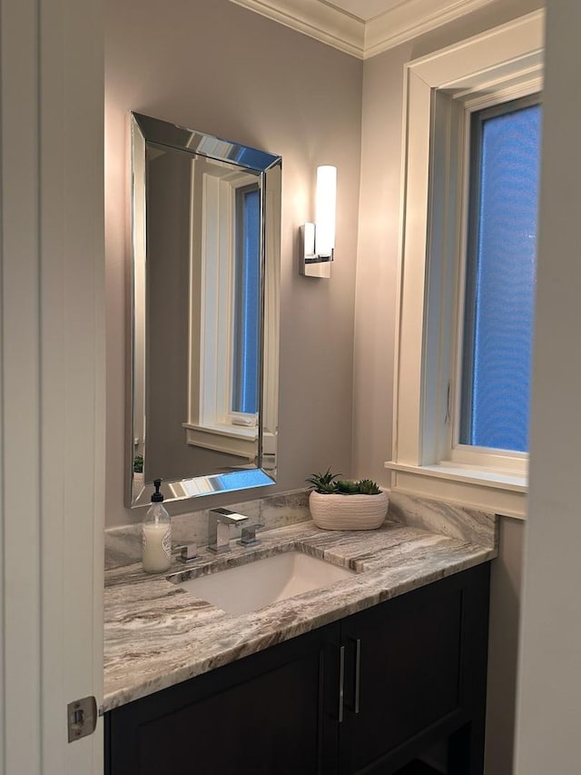 bathroom with crown molding and vanity