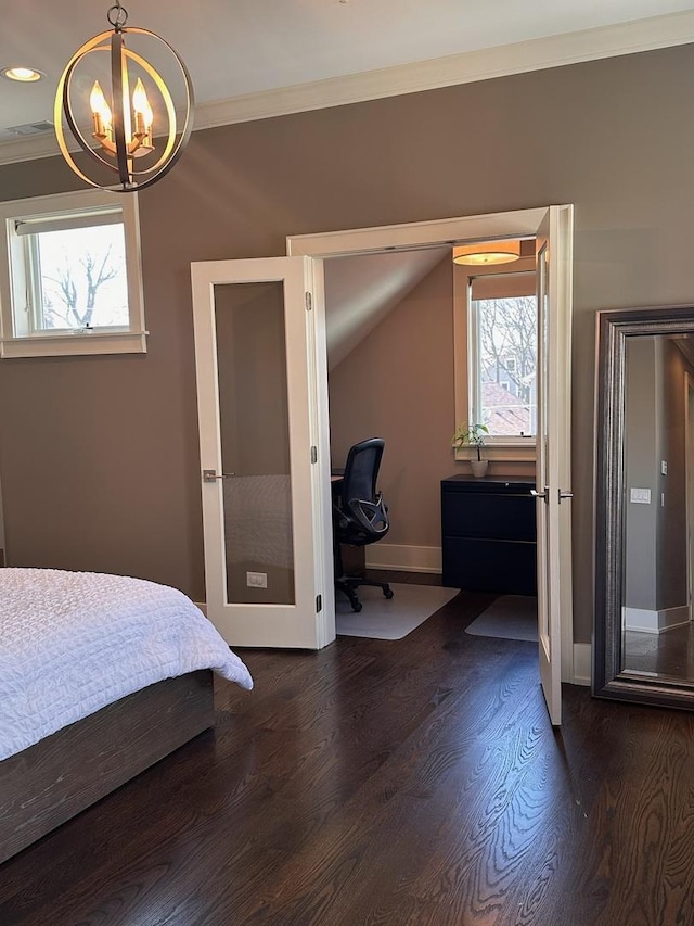 bedroom featuring crown molding, visible vents, dark wood-type flooring, a chandelier, and baseboards