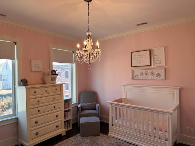 bedroom with multiple windows, visible vents, and crown molding