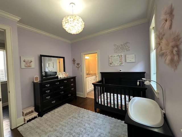 bedroom with dark wood-style floors, ornamental molding, and an inviting chandelier