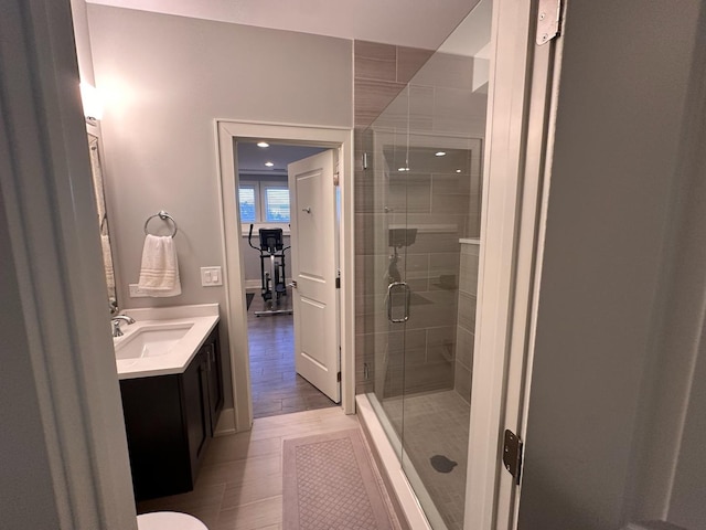 full bathroom with a shower stall and vanity