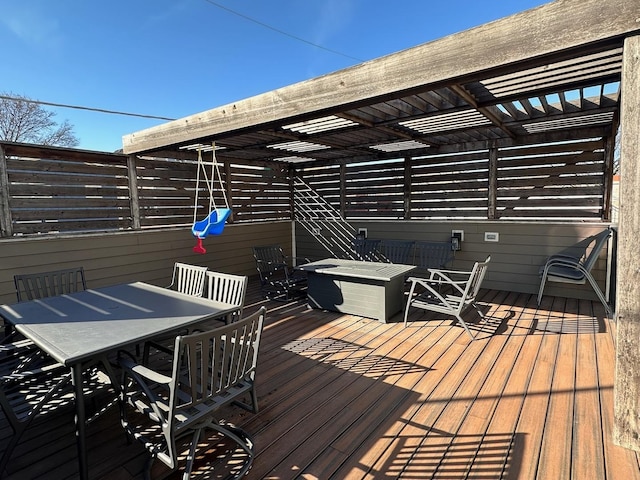 wooden deck featuring outdoor dining space and a pergola