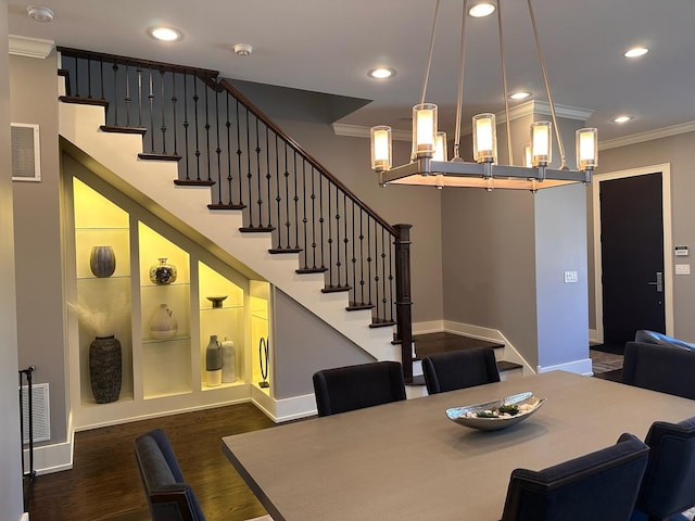 dining room featuring dark wood finished floors, crown molding, recessed lighting, visible vents, and stairway