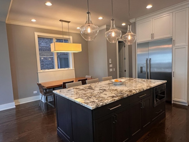 kitchen featuring light stone counters, white cabinetry, baseboards, ornamental molding, and dark wood-style floors