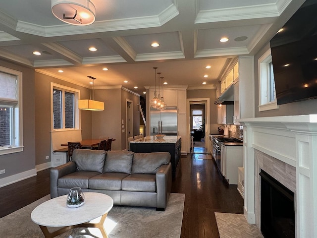 living room featuring a fireplace, coffered ceiling, and dark wood finished floors