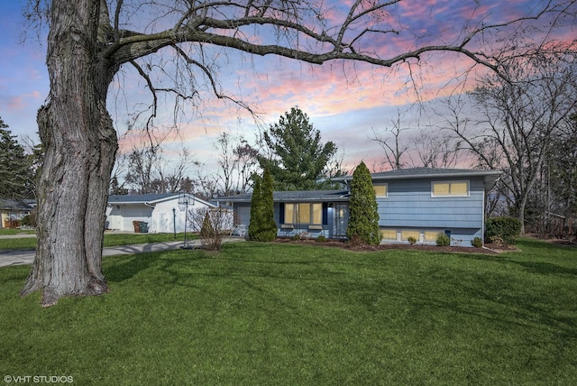 tri-level home with a front lawn and an attached garage