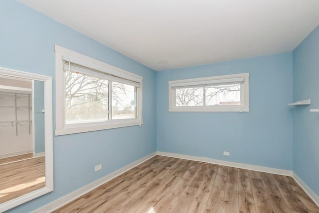 interior space with wood finished floors and baseboards