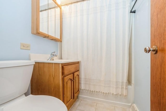 bathroom featuring tile patterned flooring, toilet, vanity, and shower / bath combo