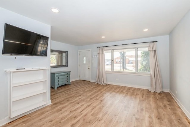 unfurnished living room featuring light wood-style flooring, recessed lighting, and baseboards