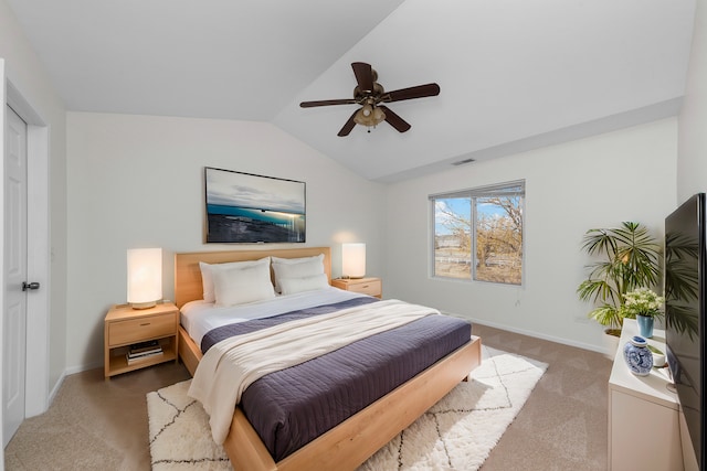 bedroom with vaulted ceiling, ceiling fan, baseboards, and light colored carpet