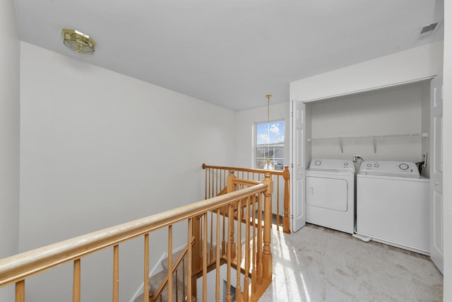 washroom featuring laundry area, visible vents, and washer and clothes dryer