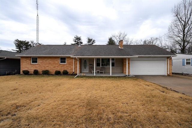 single story home with brick siding, a chimney, concrete driveway, an attached garage, and a front lawn