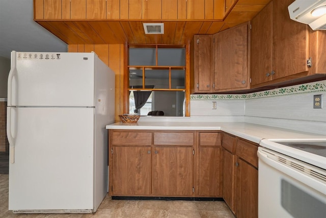 kitchen featuring wooden ceiling, white appliances, exhaust hood, light countertops, and brown cabinetry