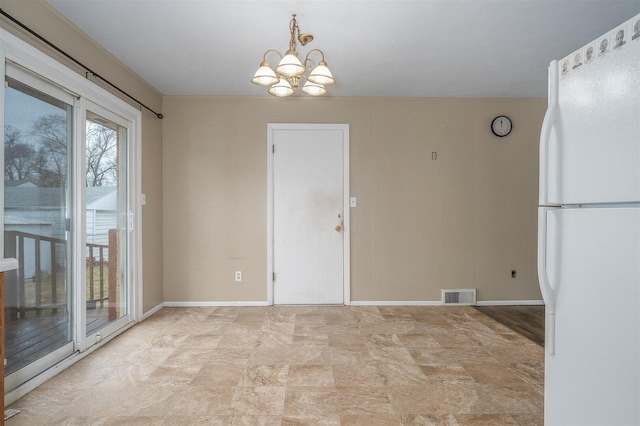 unfurnished dining area featuring baseboards, visible vents, and a notable chandelier