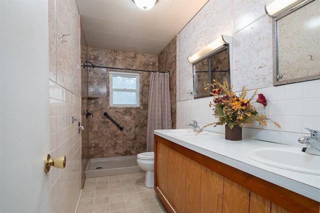 full bath with tile walls, a tile shower, and a sink