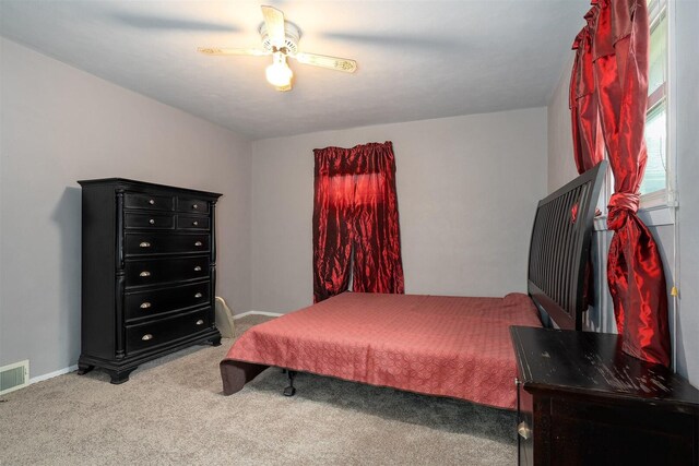 carpeted bedroom with a ceiling fan and baseboards