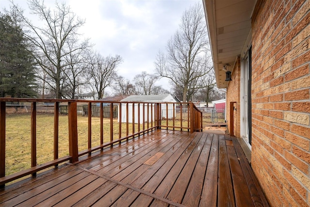 deck with a yard and fence