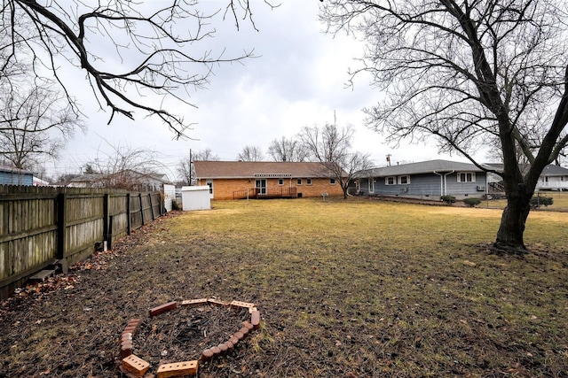 rear view of property with a yard and a fenced backyard