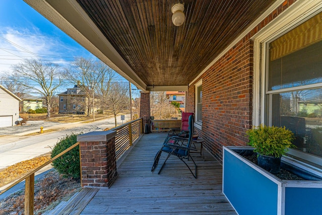 wooden terrace featuring covered porch