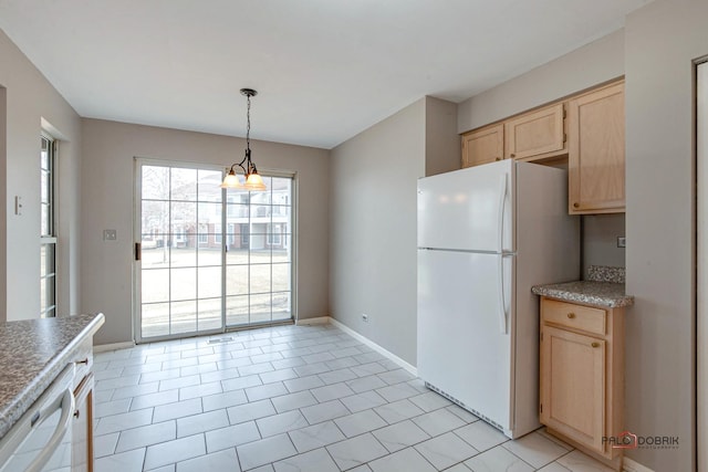 kitchen with baseboards, white appliances, light brown cabinets, and pendant lighting