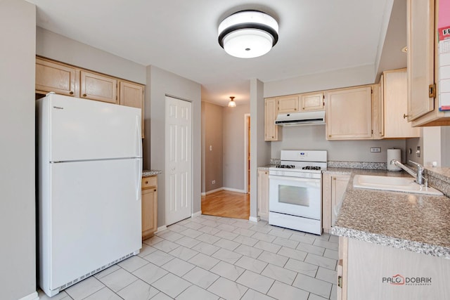 kitchen with light countertops, light brown cabinets, a sink, white appliances, and under cabinet range hood