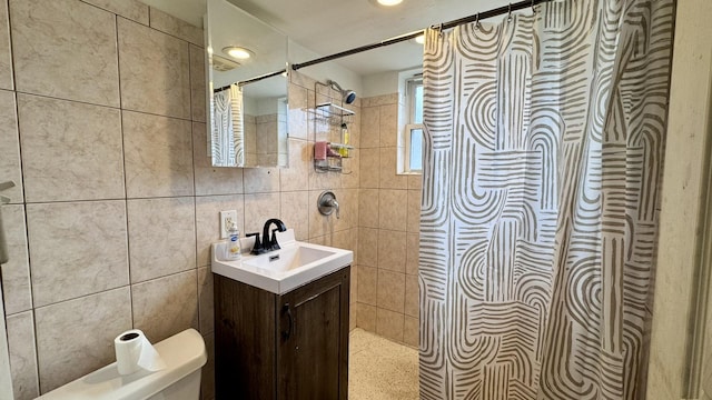 full bath featuring vanity and tile walls