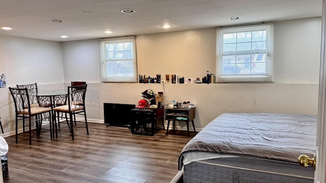 bedroom with multiple windows, wood finished floors, and recessed lighting