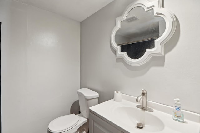 bathroom with toilet and vanity