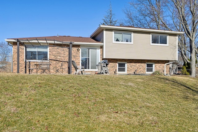 rear view of property featuring a pergola, a yard, fence, and brick siding