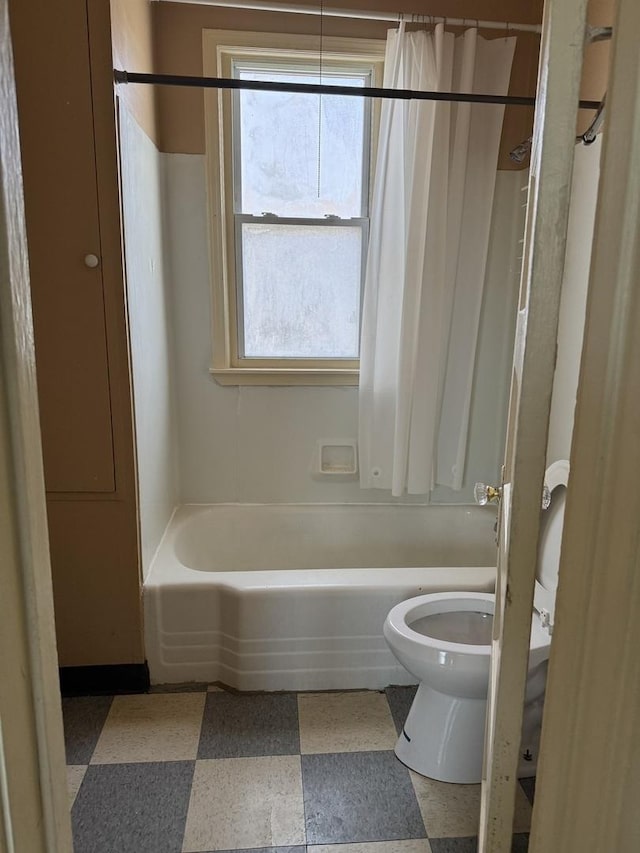 bathroom with shower / bath combination, toilet, and tile patterned floors