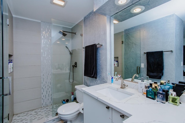 bathroom with toilet, a walk in shower, and vanity