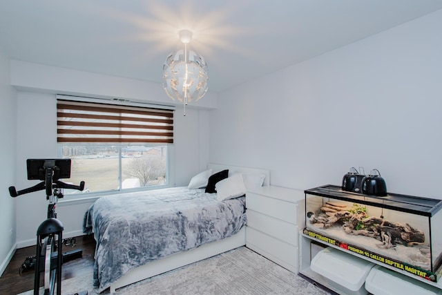 bedroom with baseboards and wood finished floors